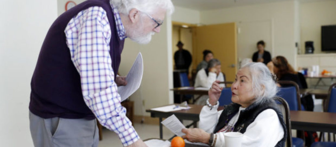 In this Friday, April 13, 2018 photo, Patrick Arbore, left, talks to Corazon Leano as he conducts an anti-bullying class at the On Lok 30th Street Senior Center in San Francisco. Nursing homes, senior centers and other places older adults gather are confronting a problem long thought the domain of the young: Bullying. (AP Photo/Marcio Jose Sanchez)